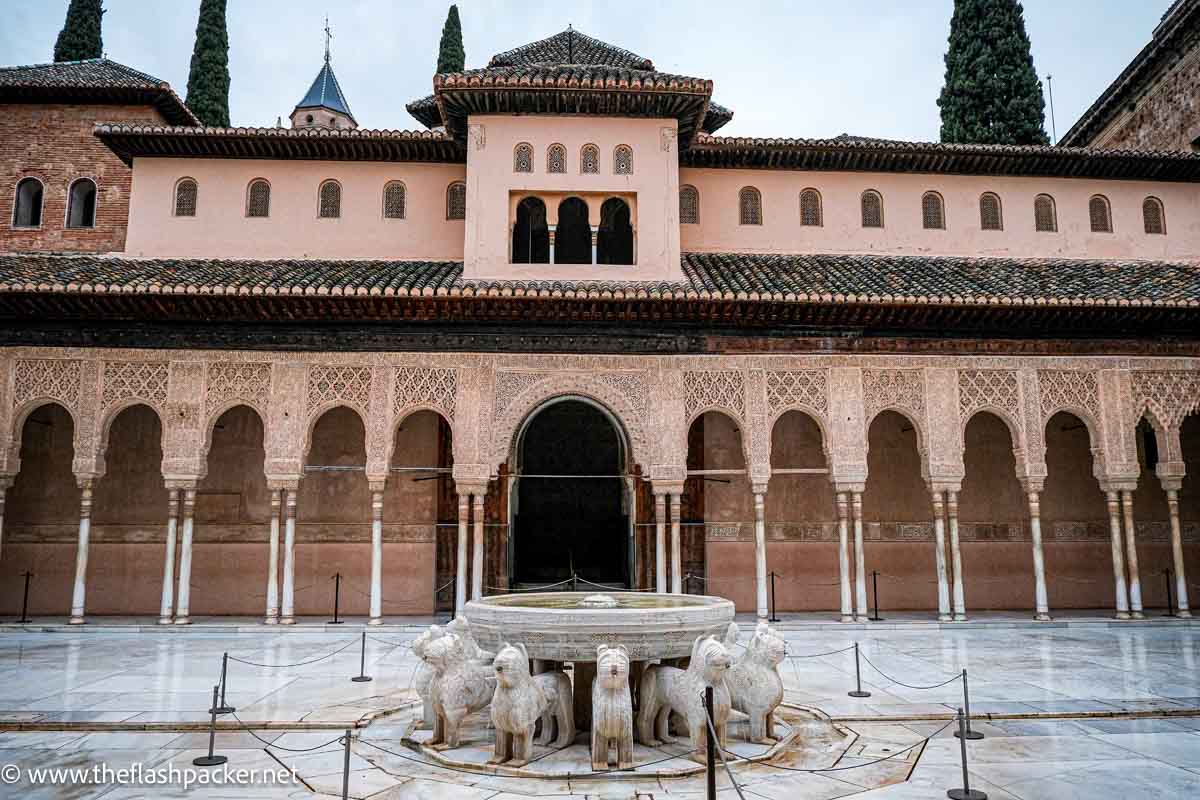 courtyard seen when visiting the Alhambra palace with a central fountain with lion sculptures