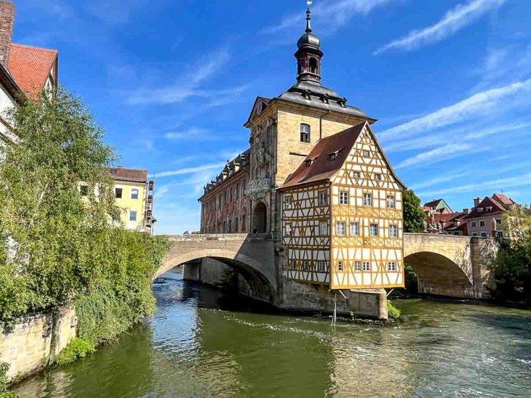 medieval building on an island with a bridge on either sdie