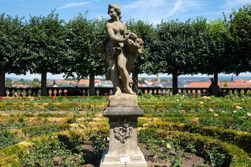 stone sculpture in bamberg rose garden with skyline of old town in background