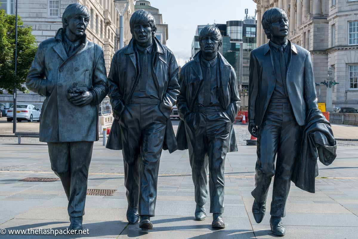 iron statue of the beatles in liverpool england