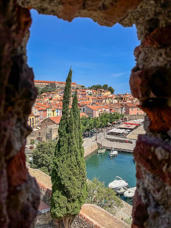 view of the harbourside of collioure in france with cafes and small boats