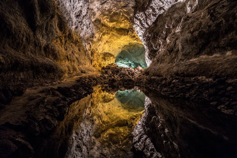 underground lagoon in cave with reflections of cave wall