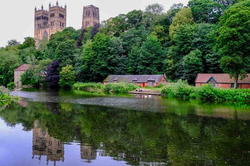 durham castle reflected in the water of river