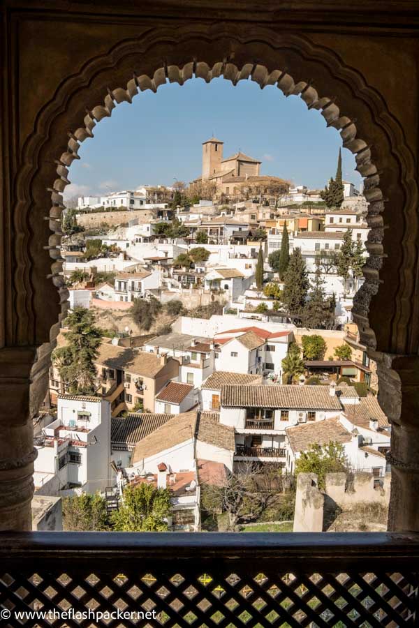 view of the rooftops of granada through keyhole shaped window