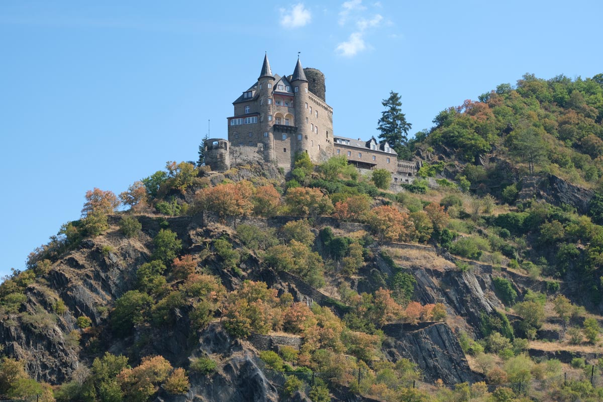 magnificent old castle on top of a grassy hill in germany romantic rhine valley