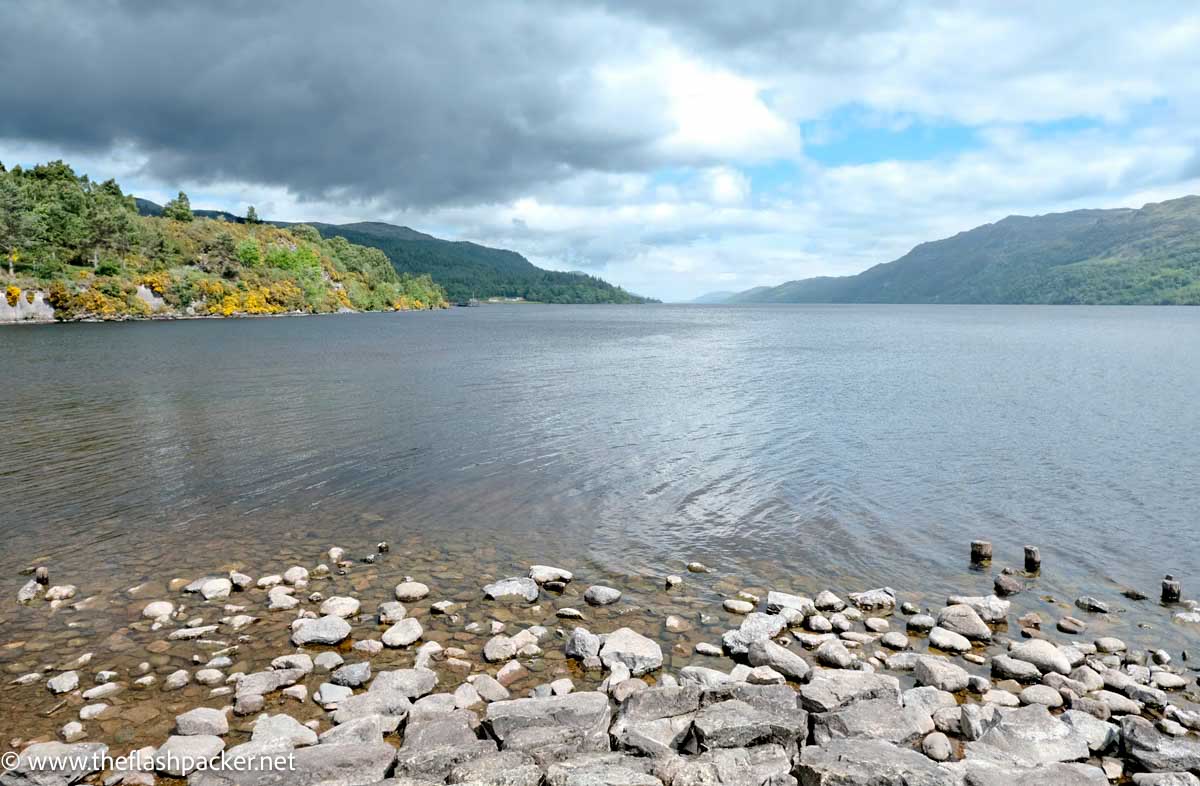 clam water of lake with stones in foreground