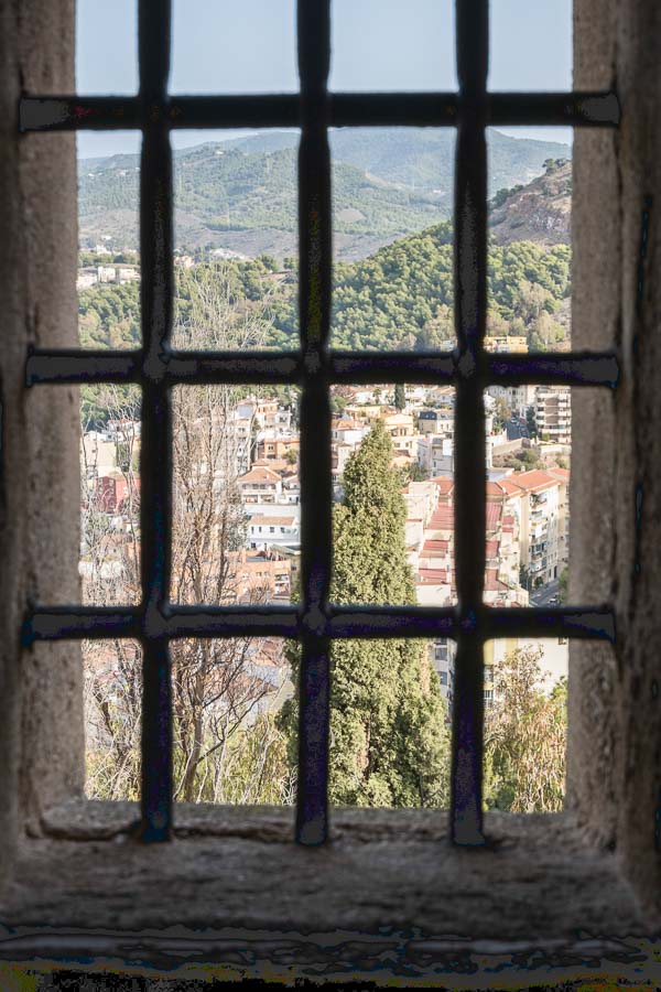 view of city of malaga and countryside through window frame