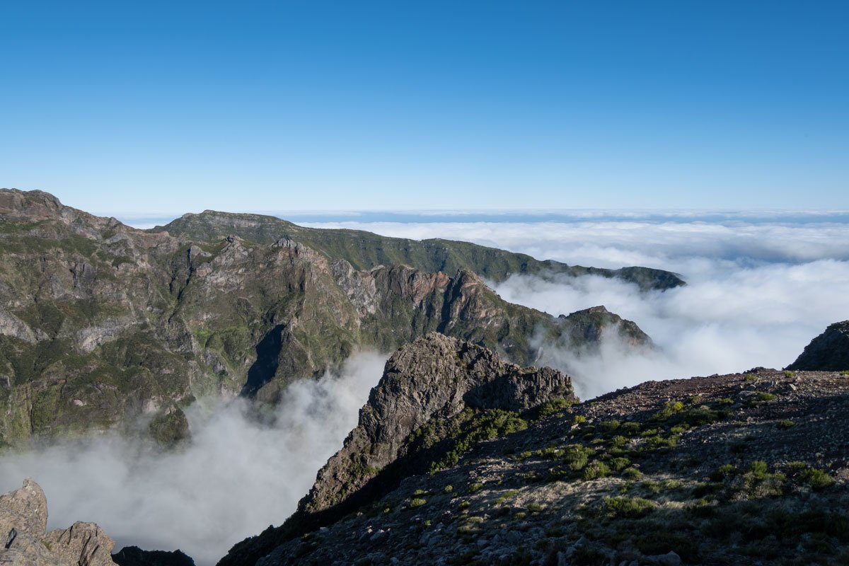 clouds hanging over the jagged peaks of pico do arieiro seen in madeira solo travel trip