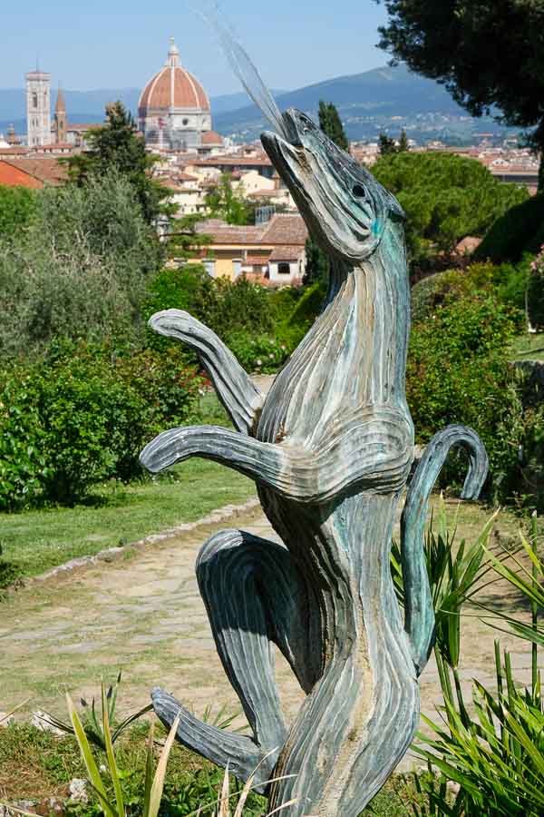 founatin of creature shooting water from its mouth with one of the best views of florence in background