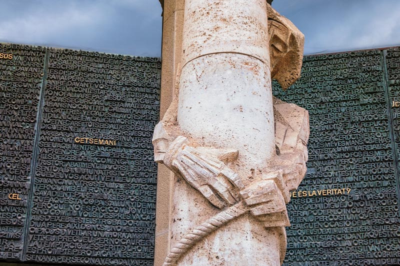 sculpture of jesus wrapped around a column