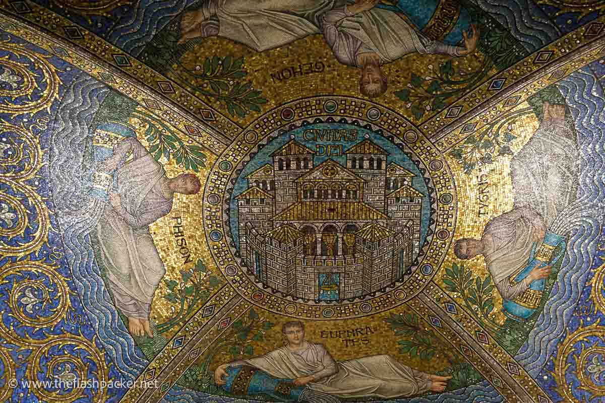 gold and blue mosaic of a holy church surrounded by 4 classical figures