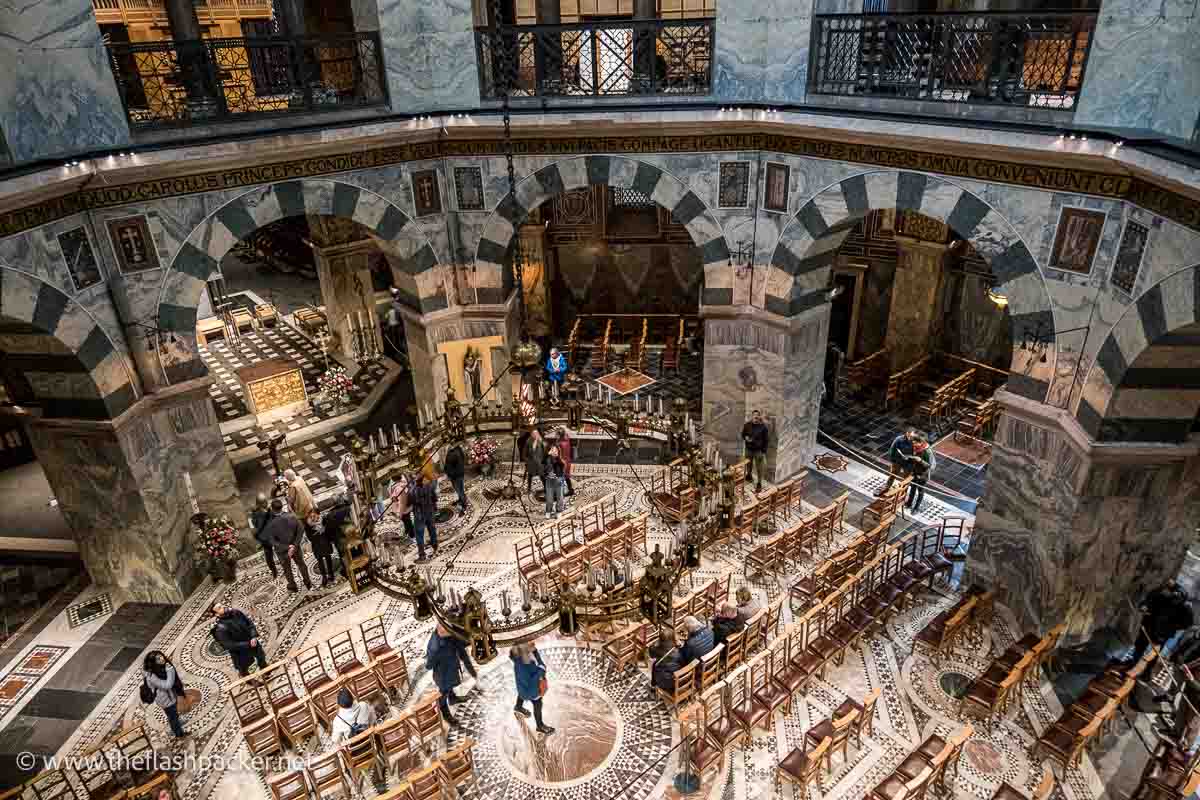 people and chairs on the floor of aachen cathedral