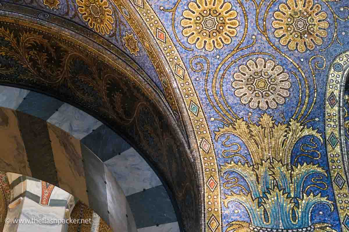 blue and gold mosaics on an arch seen visiting aachen cathedral