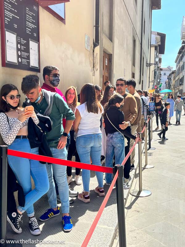 poeple in a queue outside the accademia gallery in florence italy