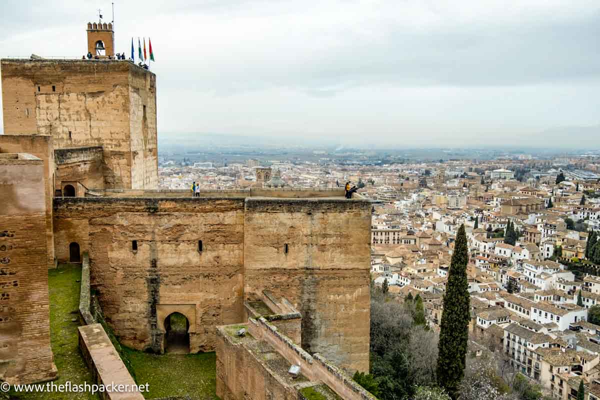 pathway leading to tower of fortress at the alhambras alcazaba with views over granada