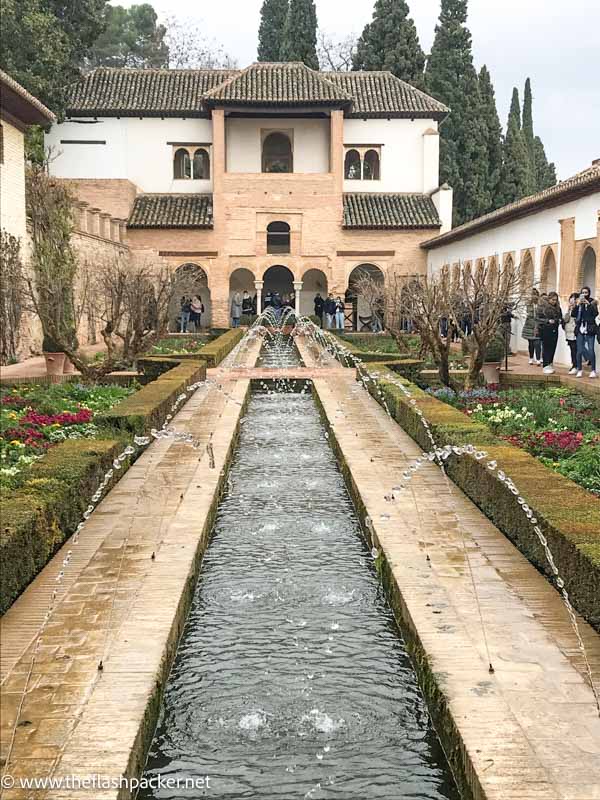 long rectangular fountain in terraced courtyard at generalife gardens at alhambra spain