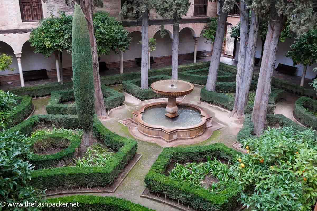 courtyard garden with hedges tress and central fountain