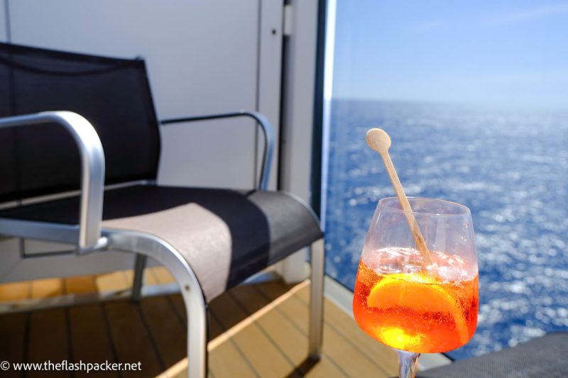 balcony of cabin on adriatic sea cruise with aperol spritz drink on table