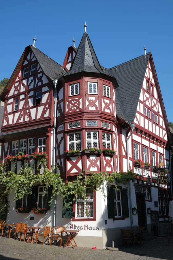 red and white half timbered building with the name altes haus