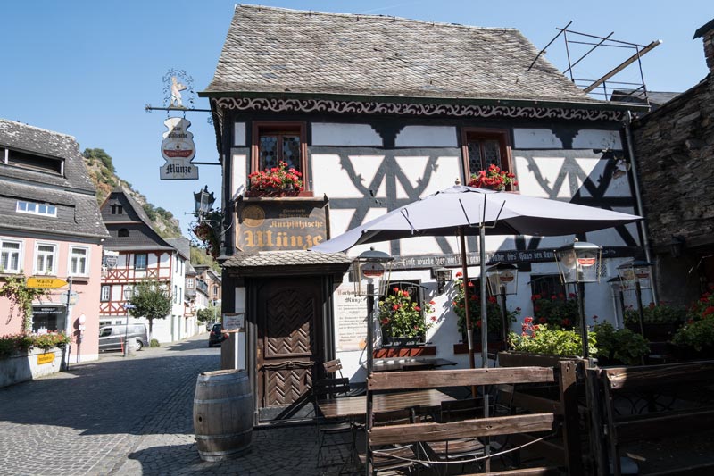 half-timbered building called munze on a pretty cobblestone street