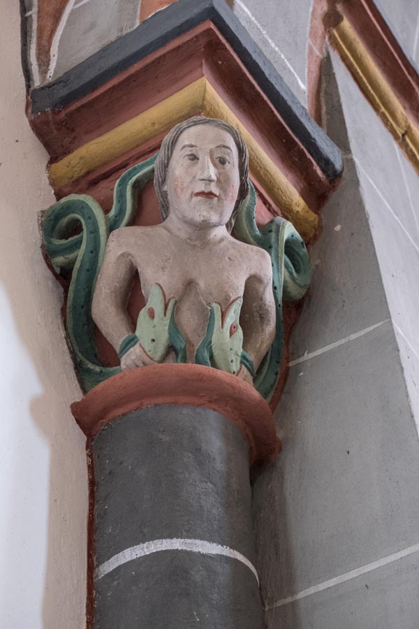 sculpture of naked woman with 2 green serpents