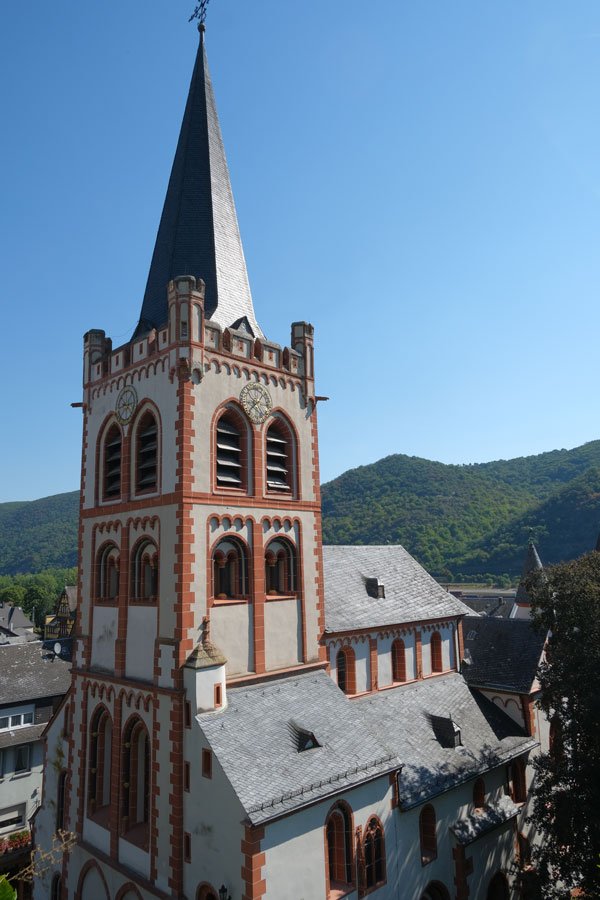 exterior of bacharach protestant church with tall bell tower and grey spire