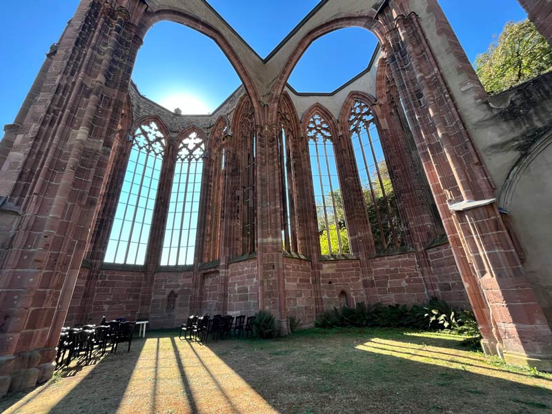 shell of ruined church with sun pouring through windows