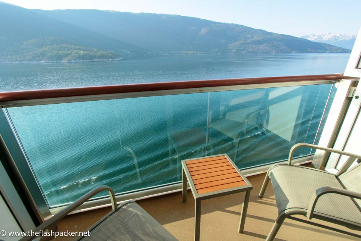 the balcony of a cruise ship cabin looking out to a norway fjord