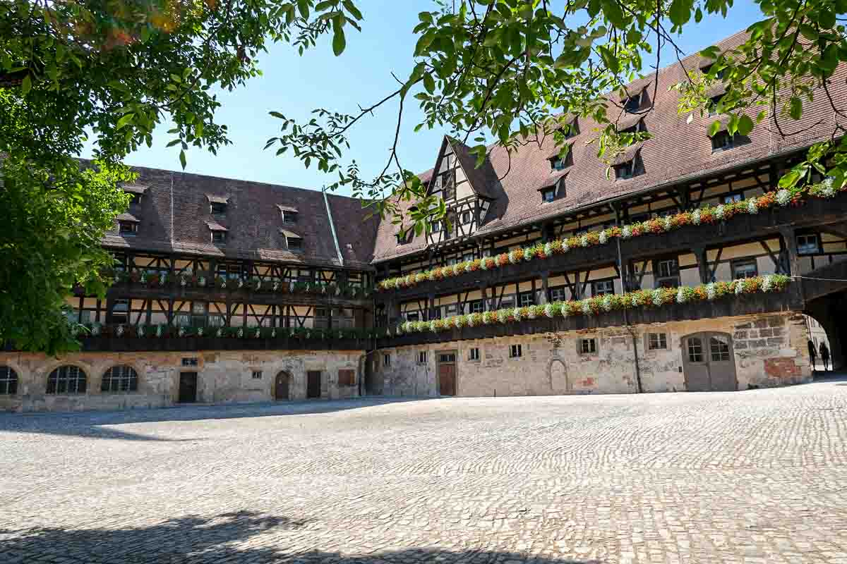 cobblestoned old courtyard in bamberg enclosed by medieval buildings