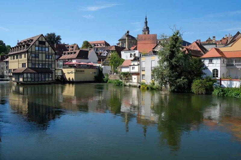 a group of medieval buildings in old town bamberg reflected in river