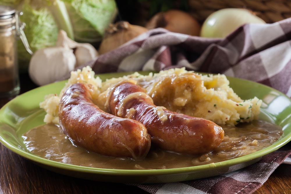 plates of sausages with mashed potatoes and onion gravy