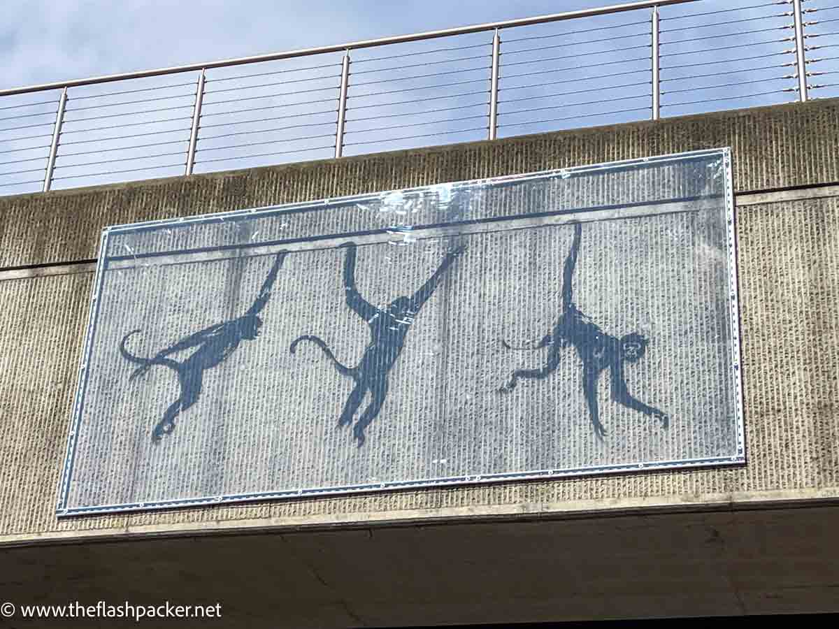 street art by banksy of three monkeys