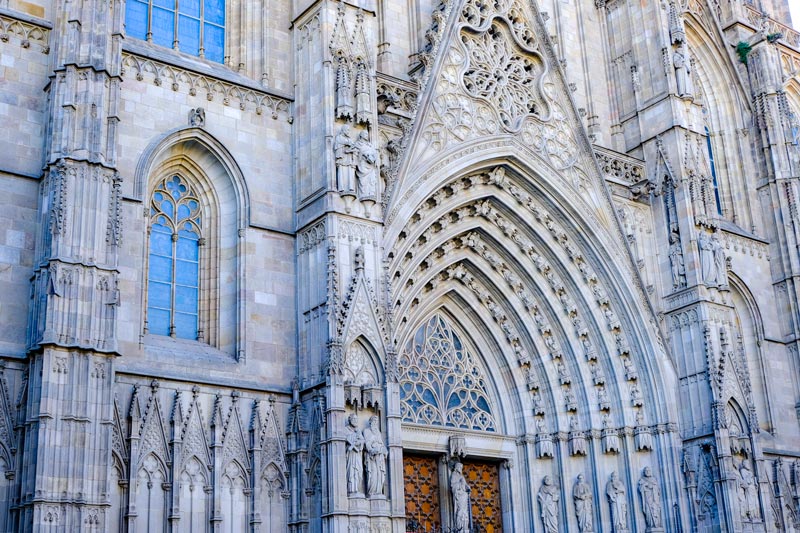 ornate gothic entrance to barcelona cathedral with intricate stone carvings