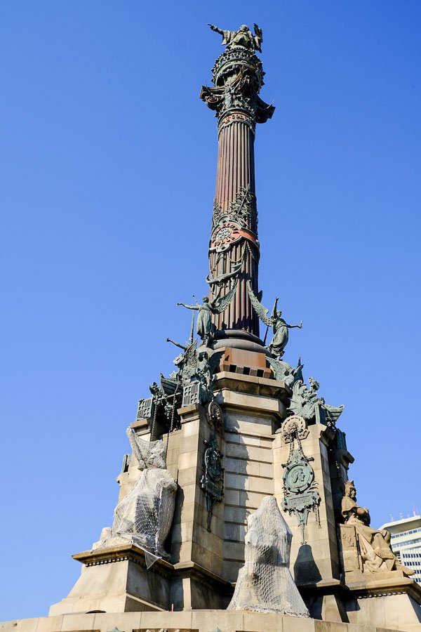 ornate monument with huge pillar surrounded by sculptures