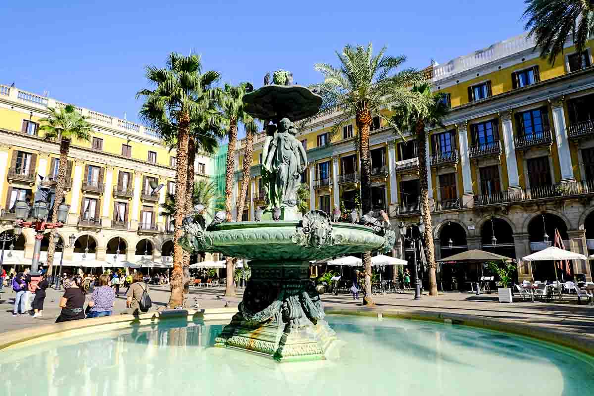 ornate fountain in grand square under blue sky