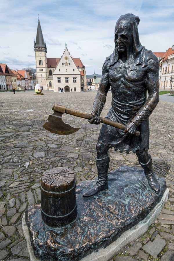 bronze sculpture of an executioner with axe and block