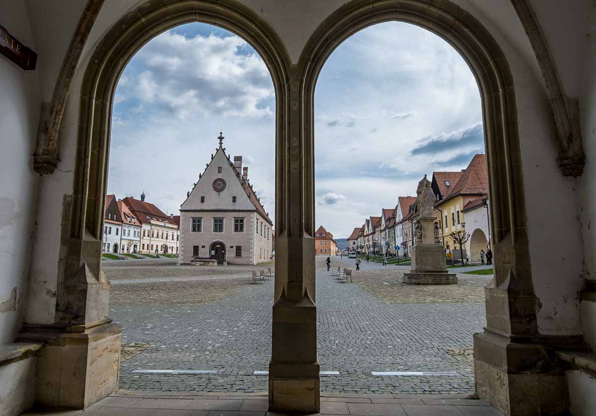 medieval main square in bardejov viewed through two arches