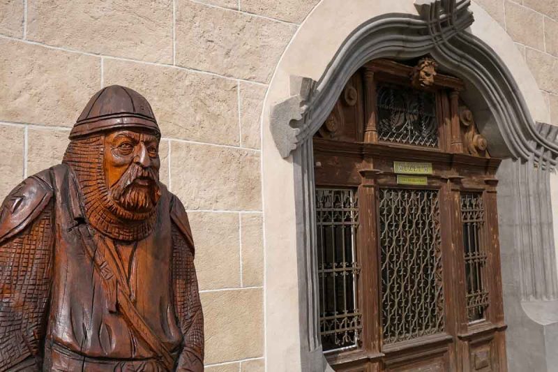 wooden sculpture of a guard by the doorway of the old town hall in bardejov