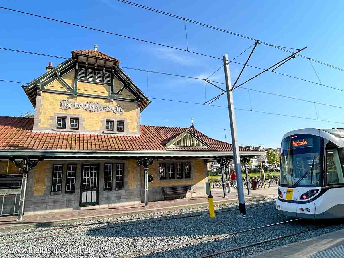 coastal tram arriving at quaint de haan station in belgium