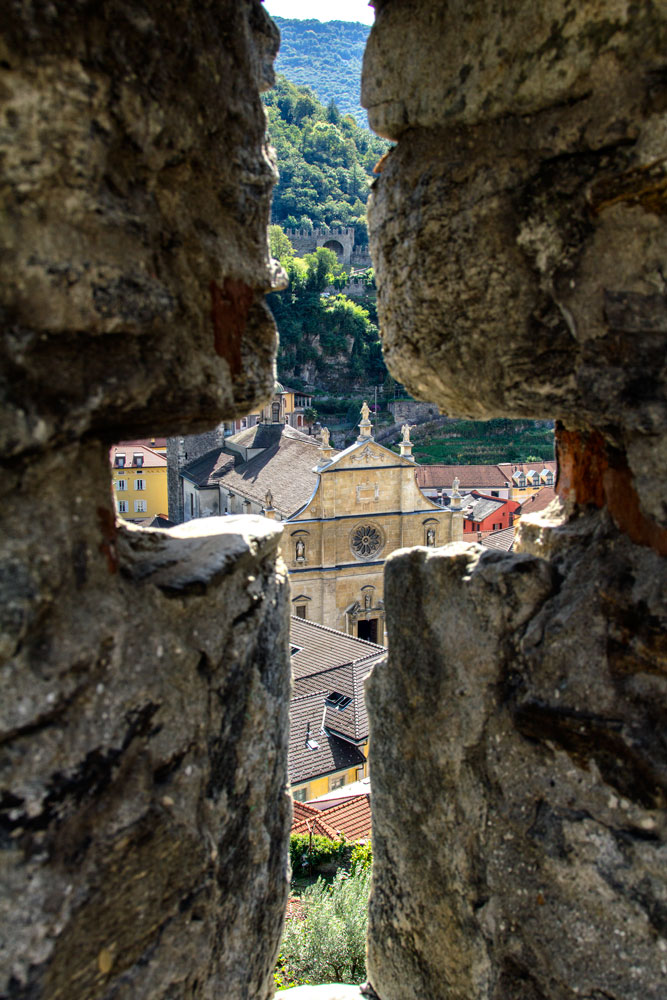 view of town on bellinzona through cross-shaped opening which is one place you can visit using the ticino ticket