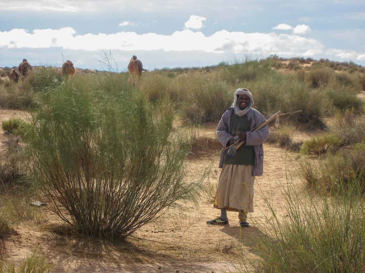 berber male with head dress carrying a stick