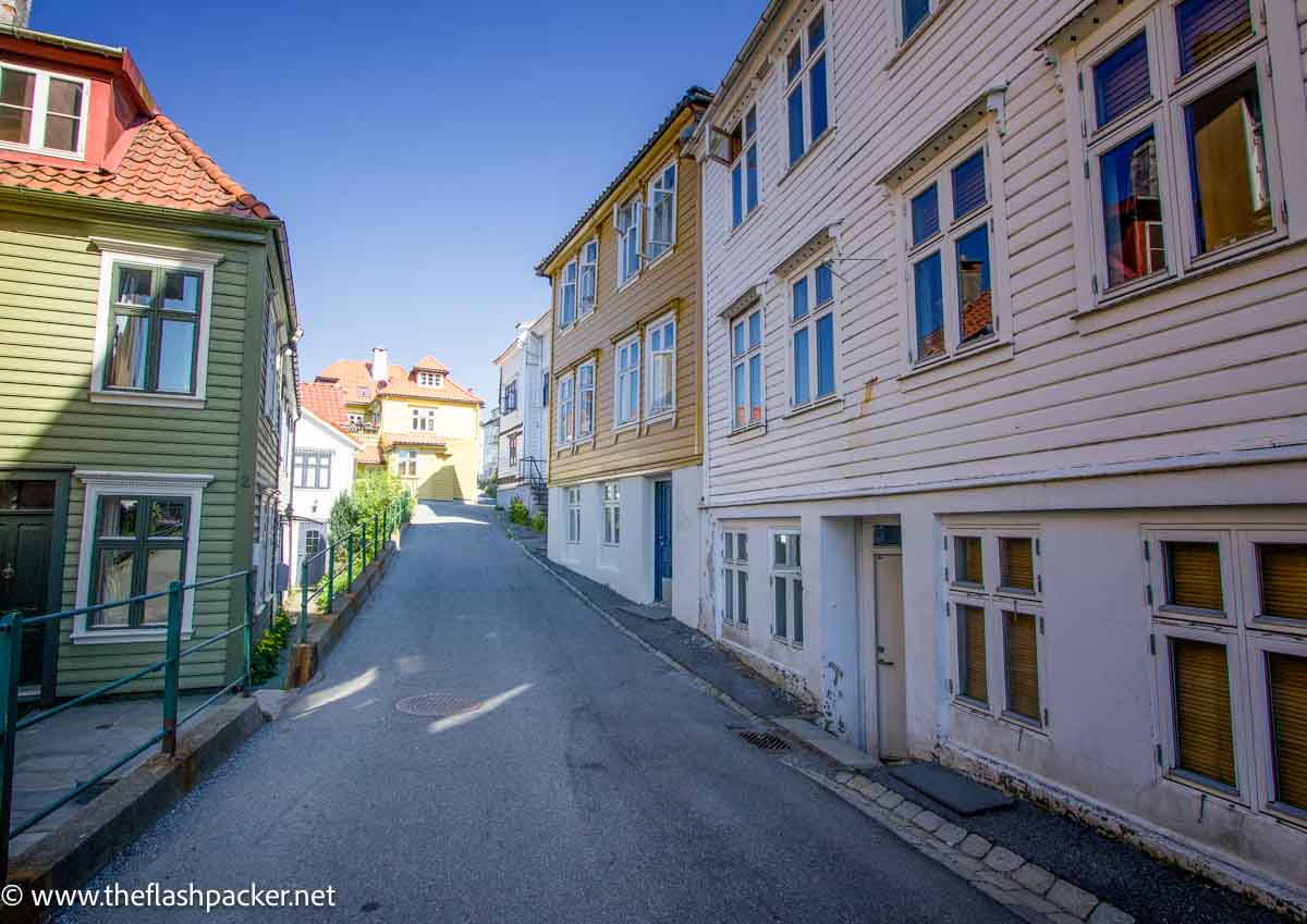 painted wooden buildings in street in bergen norway