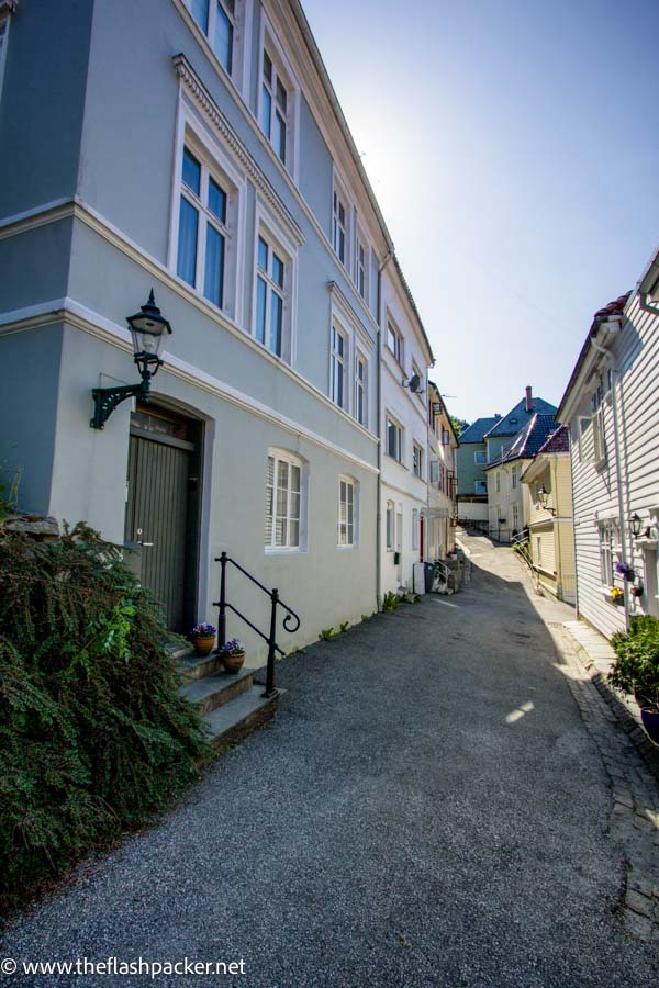 pretty cobbled lane in bergen lined with wooden framed houses