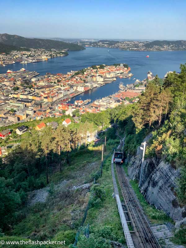 funicular train winding its way up a hillside with bay in background