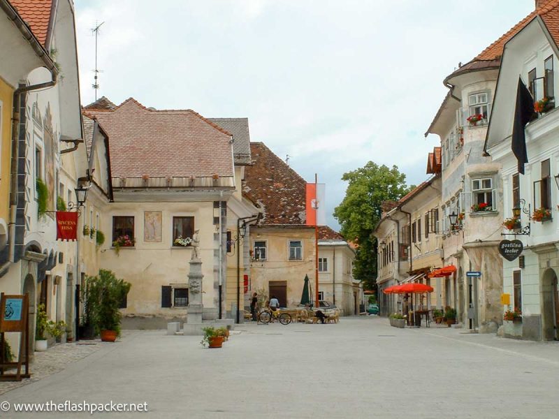 pastel coloured medieval buildings around town square in bled slovenia