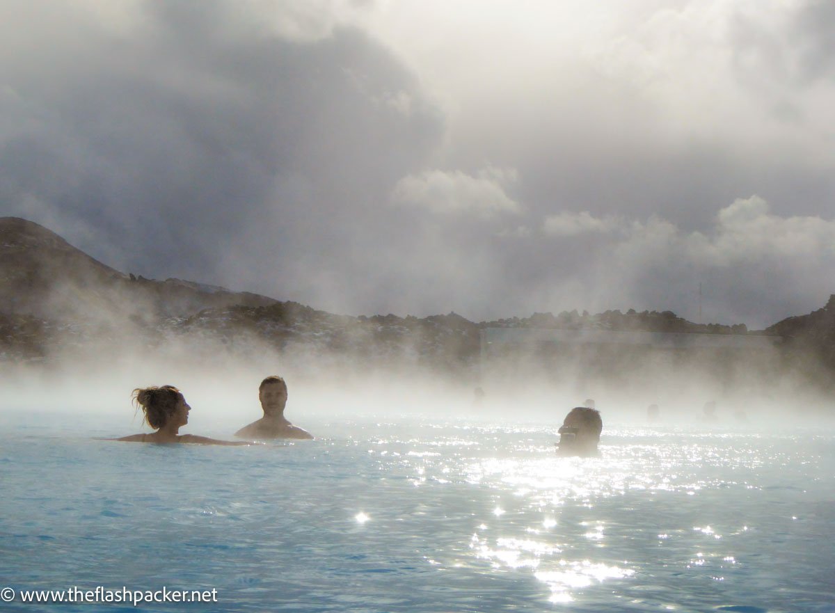 people bathing in blue lagoon iceland with steam mist