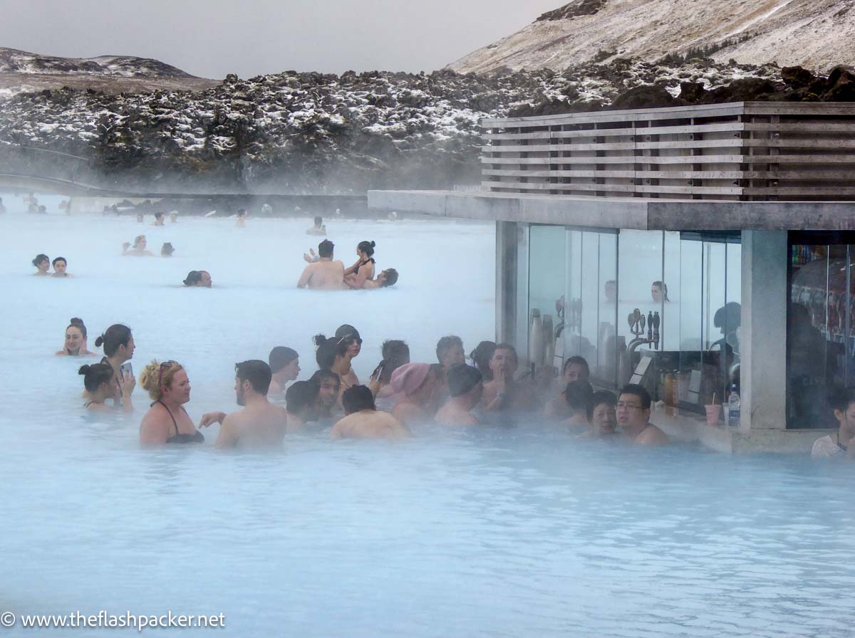 people drinking at swim up bar in blue lagoon iceland