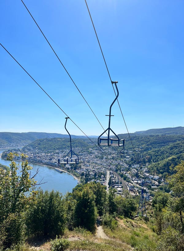 chairlift high above forsted hillside next to the rhine river