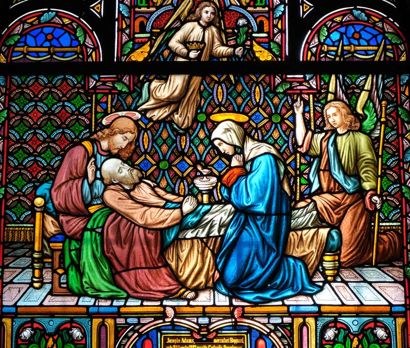 vibrant stained glass depicting biblical secne of the raising of lazarus