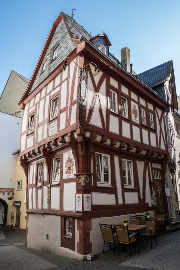 handsome half timbered building with tables and chairs outside